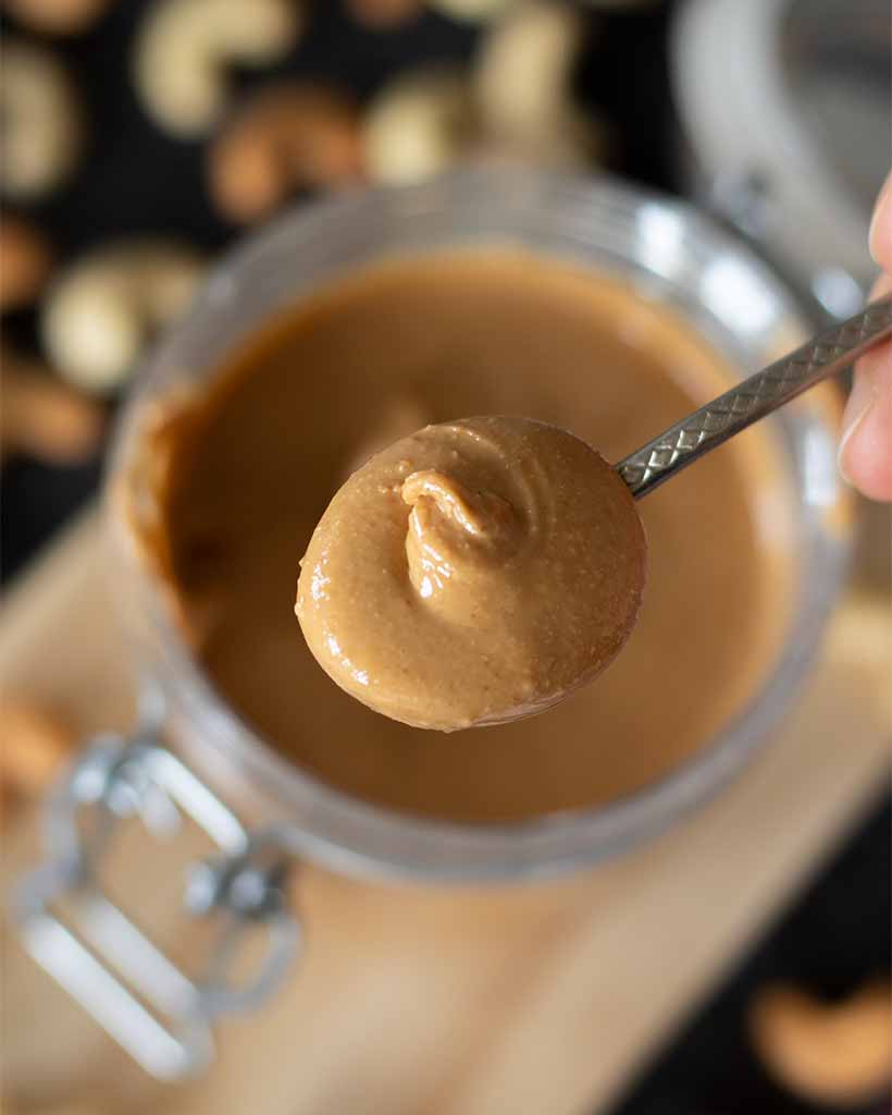 Sweet and creamy cashew nut spread in a spoon