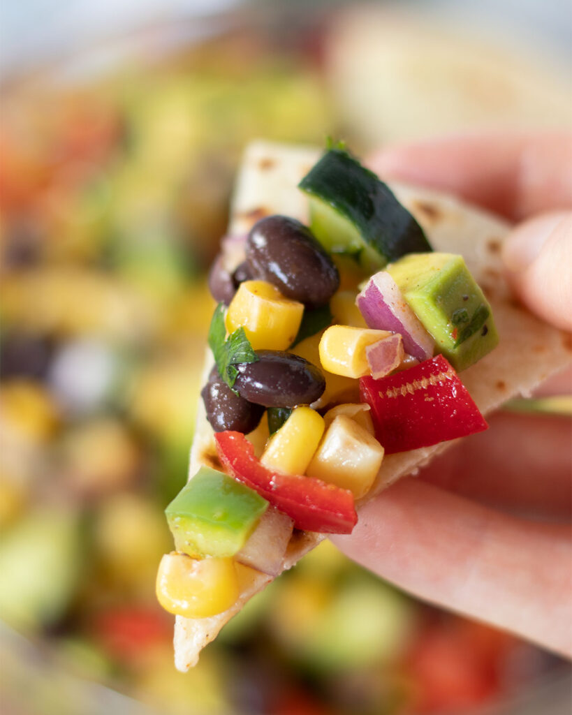 Heatlhy colorful corn salad with black beans on tortilla as an easy appetizer or side dish