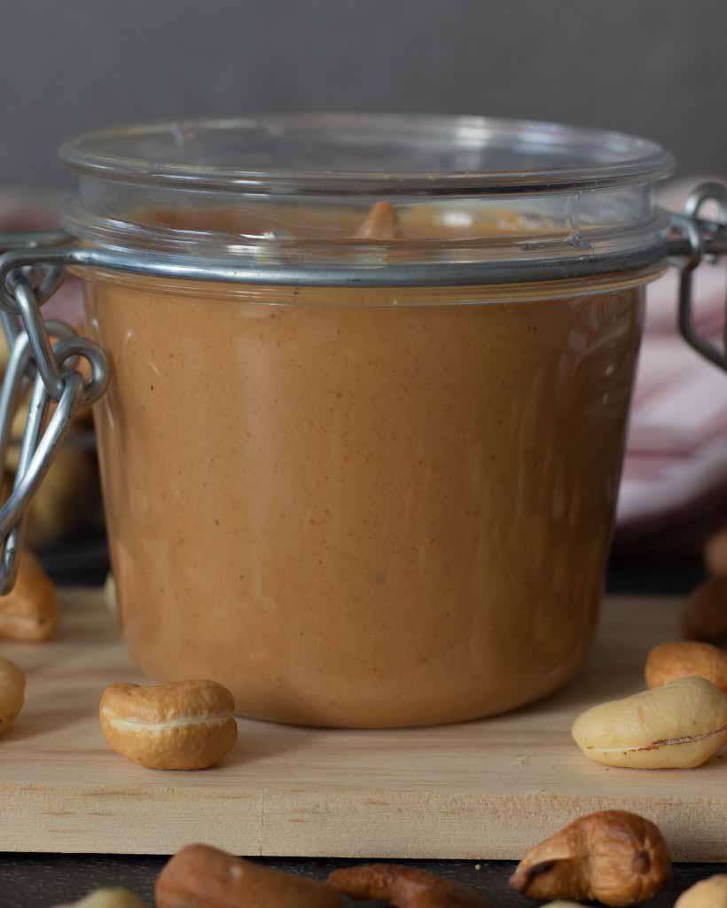 Jar full of creamy homemade cashew spread without oil