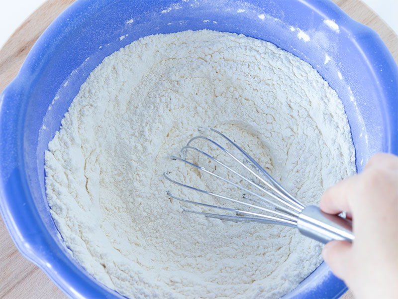 All purpose flour and salt in a bowl with a wisk