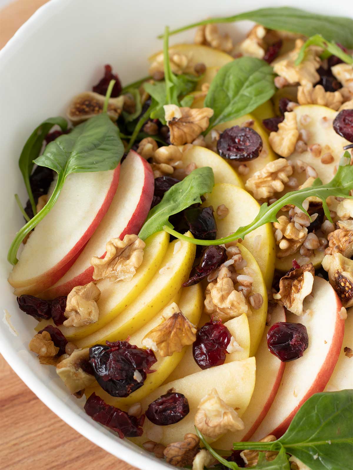 Easy vegan thanksgiving salad with apples, walnuts,spinach, buckwheat and cranberries