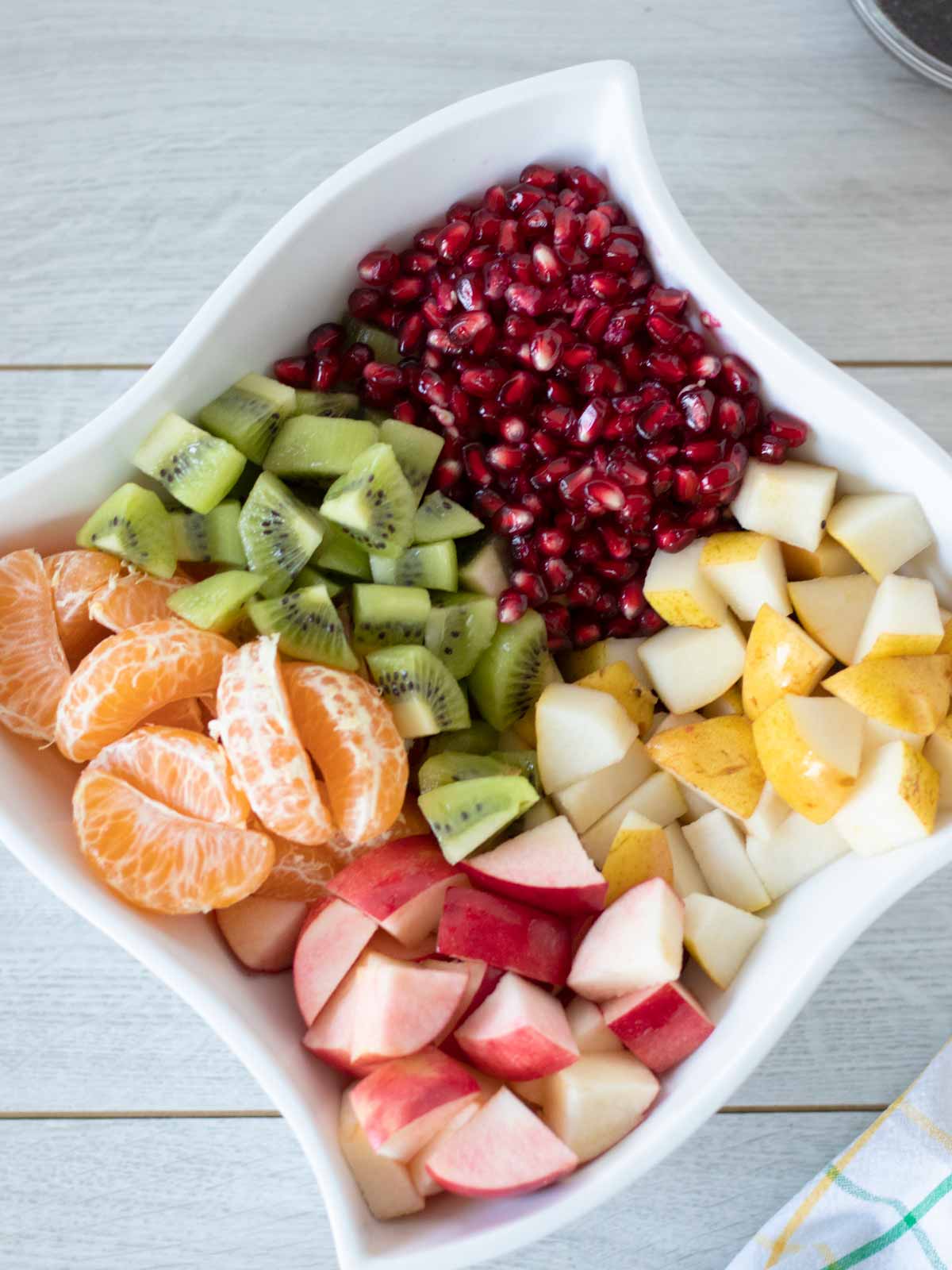 Bite-sized chopped winter fruit in a bowl