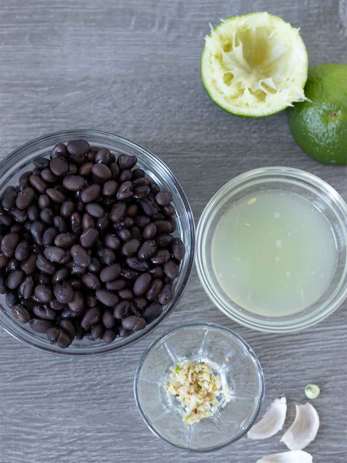 Drained and rinsed canned black beans, freshly squeezed lime juice, and minced garlic for gluten-free hummus recipe