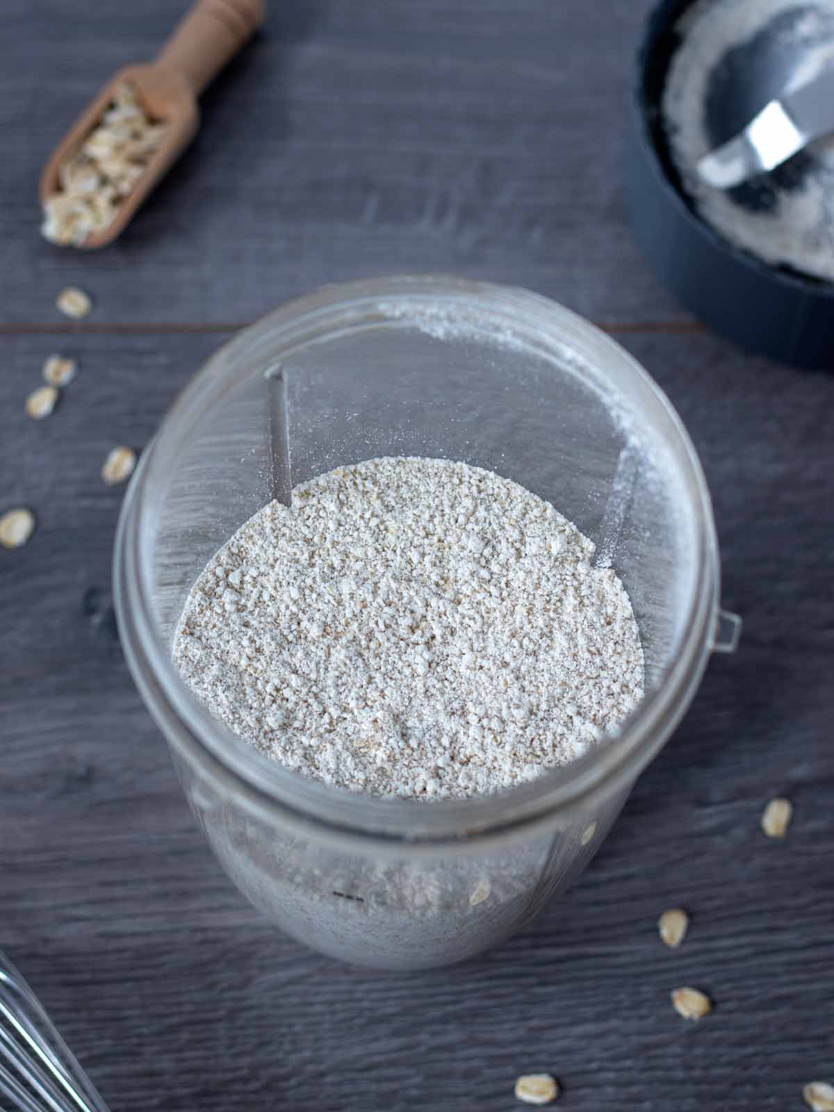 Homemade gluten-free flour made from rolled oats in a blender cup