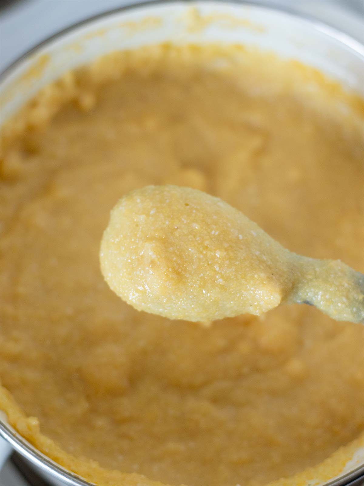 Creamy polenta in a wooden spoon