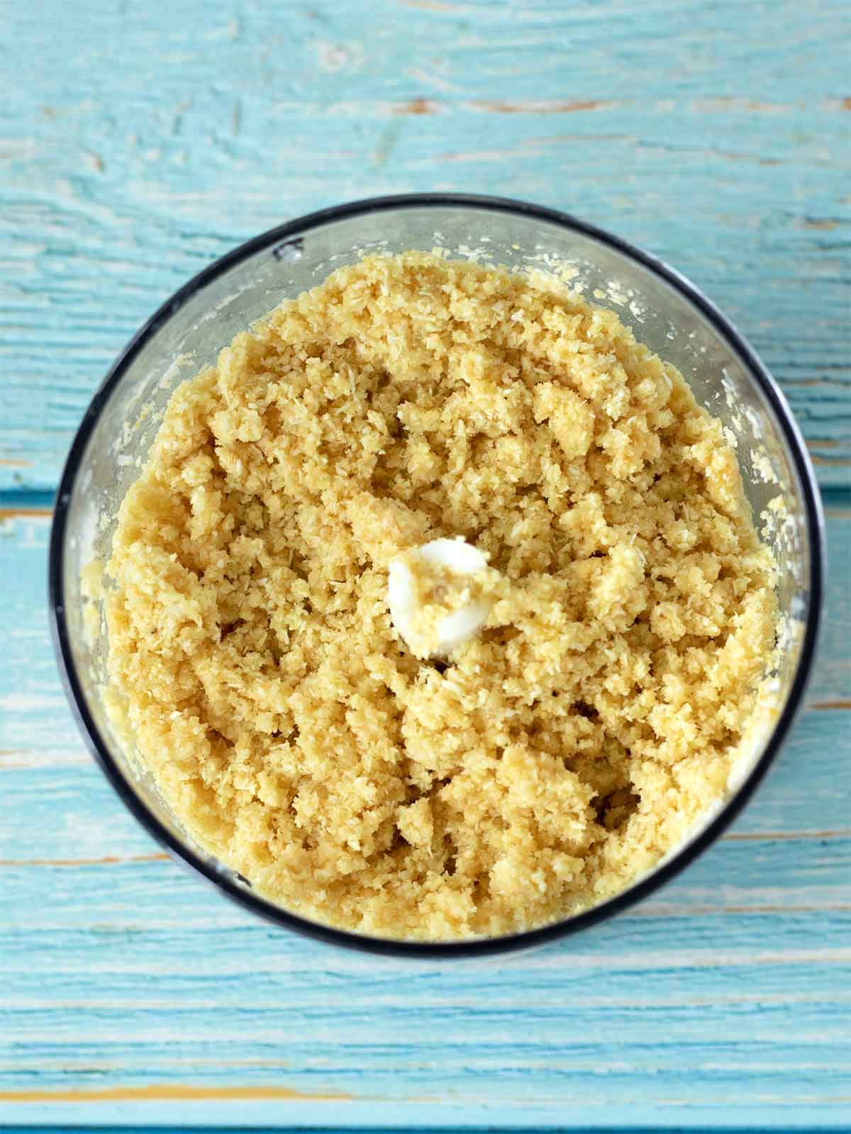 Dough for making healthy no-bake coconut balls in a food processor