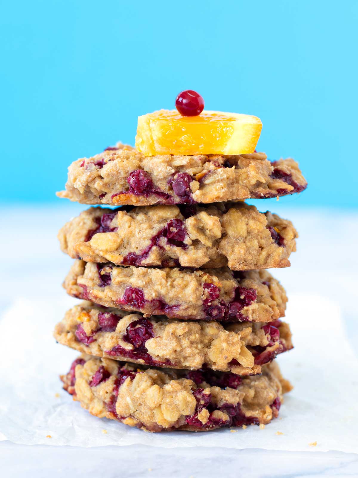 A stack of healthy gluten-free cranberry orange oatmeal cookies (vegan)