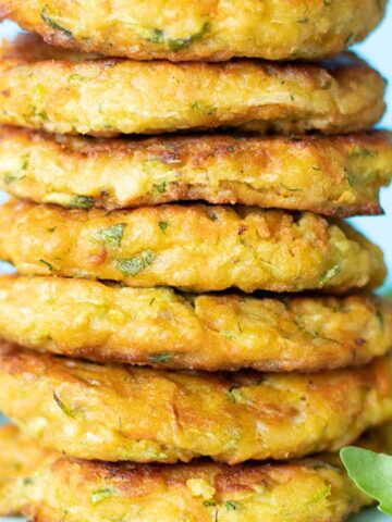 A stack of crispy vegan zucchini fritters with chickpea flour and carrots