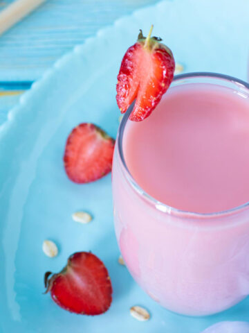 Homemade strawberry oat milk in a glass