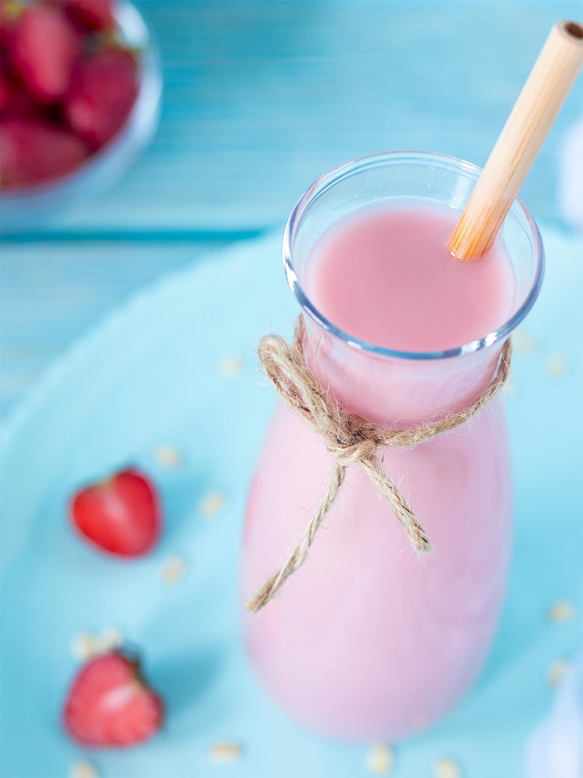 Cold vegan homemade nut milk in glass jar and bamboo straw