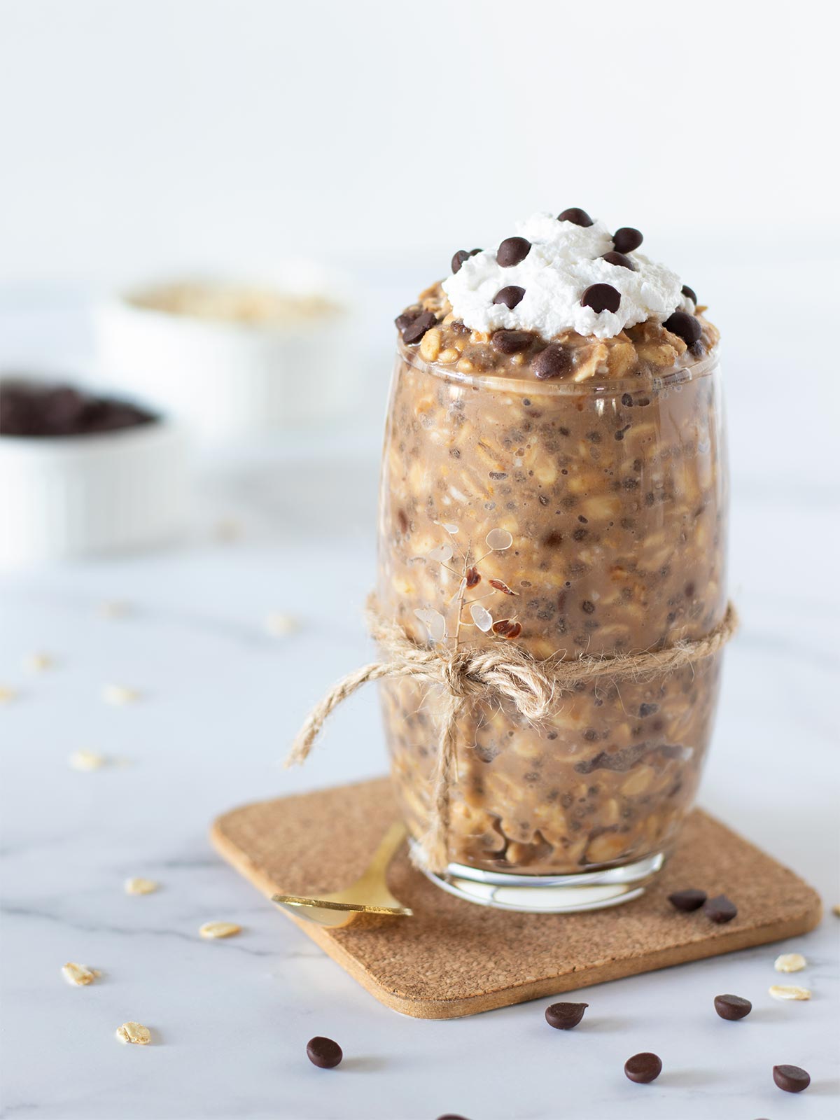 Healthy cookie dough overnight oats with peanut butter and chia seeds in a glass.