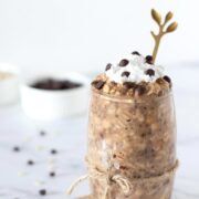 Healthy protein chocolate chip cookie dough overnight oats without yogurt topped with whipped cream in a glass.