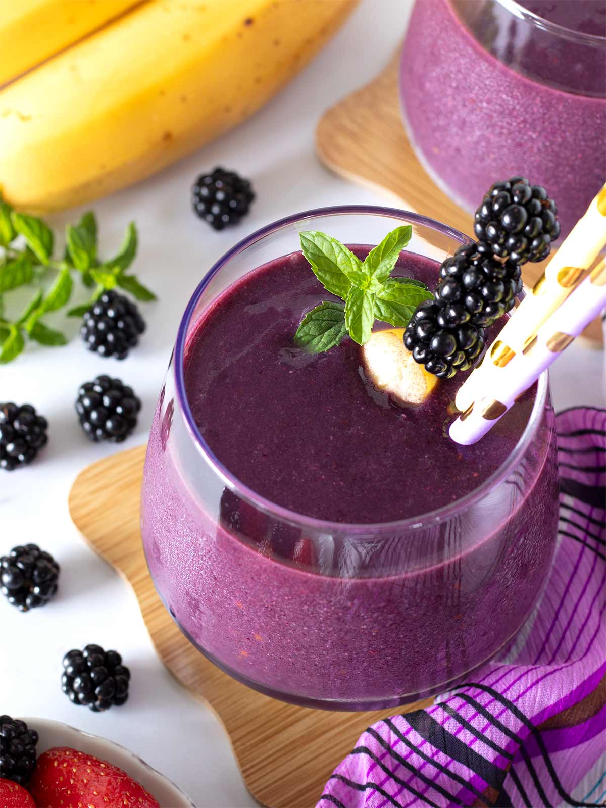 No-yogurt blackberry fruit smoothie in glass with fresh mint.