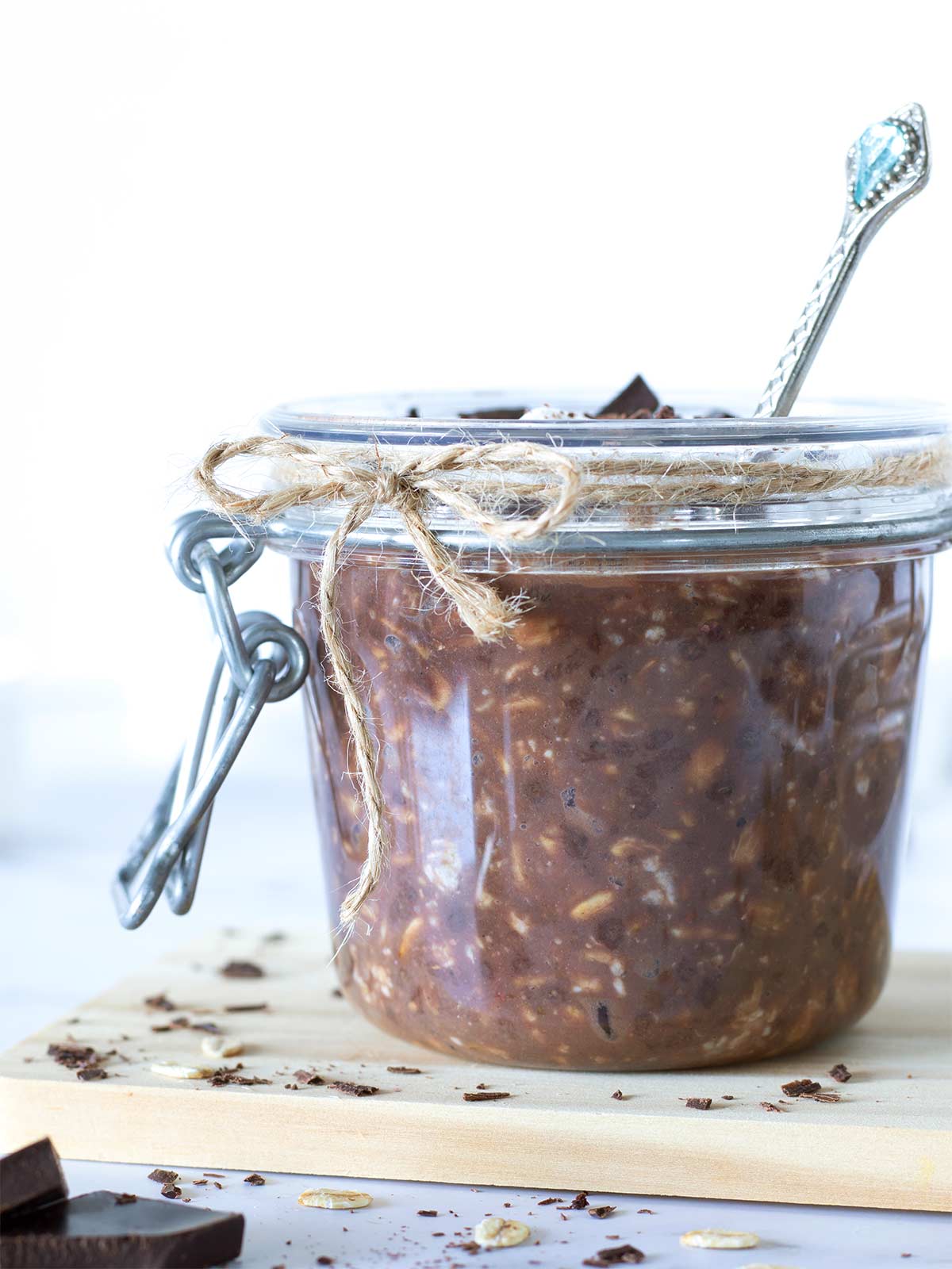 Vegan chocolate overnight oats with protein powder in a jar with spoon.