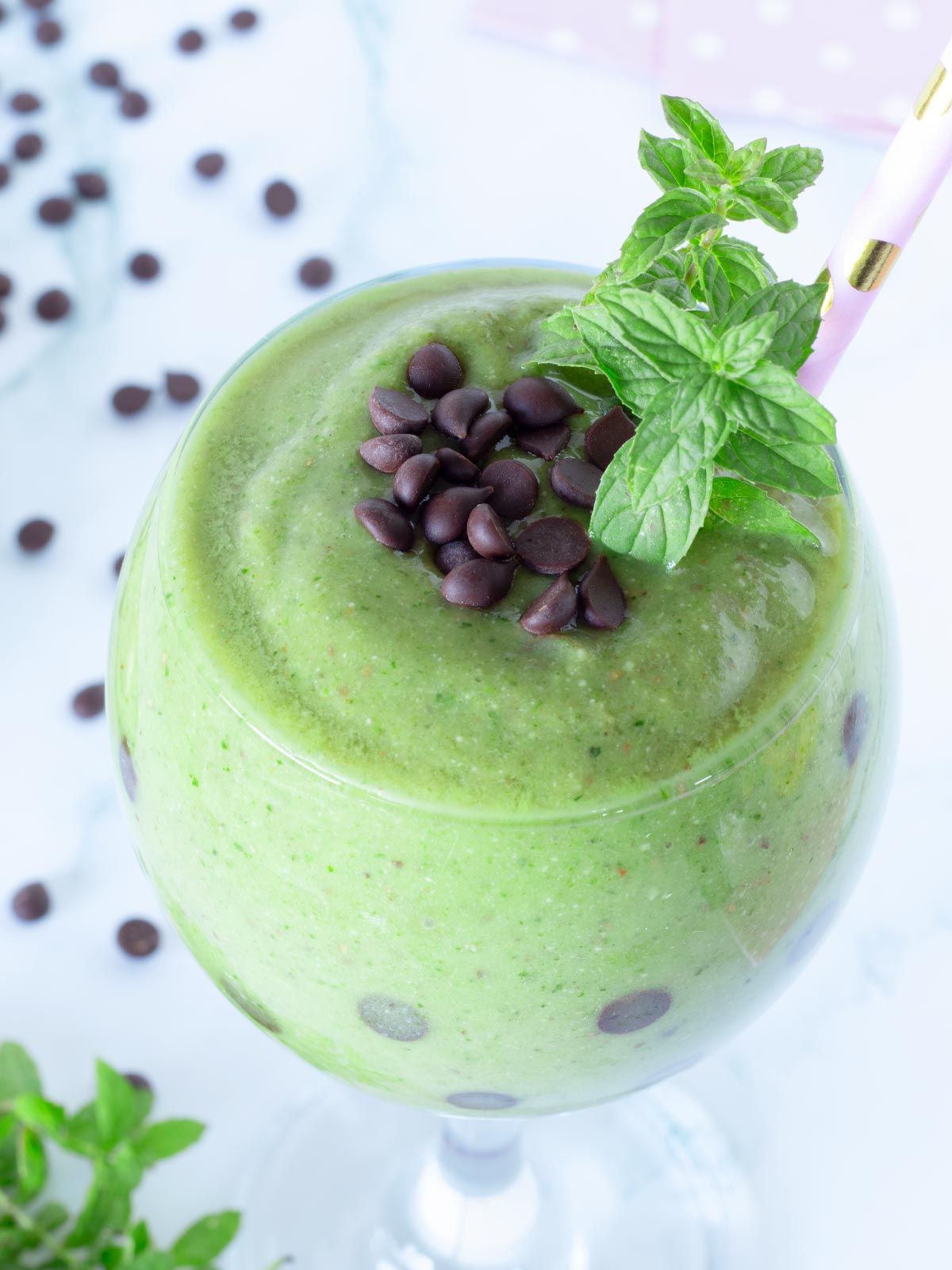Green mint smoothie with chocolate chips and banana.