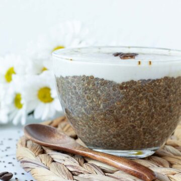 Morning cup of coffee chia pudding topped with vegan creamear.