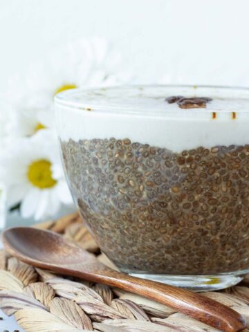 Morning cup of coffee chia pudding topped with vegan creamear.