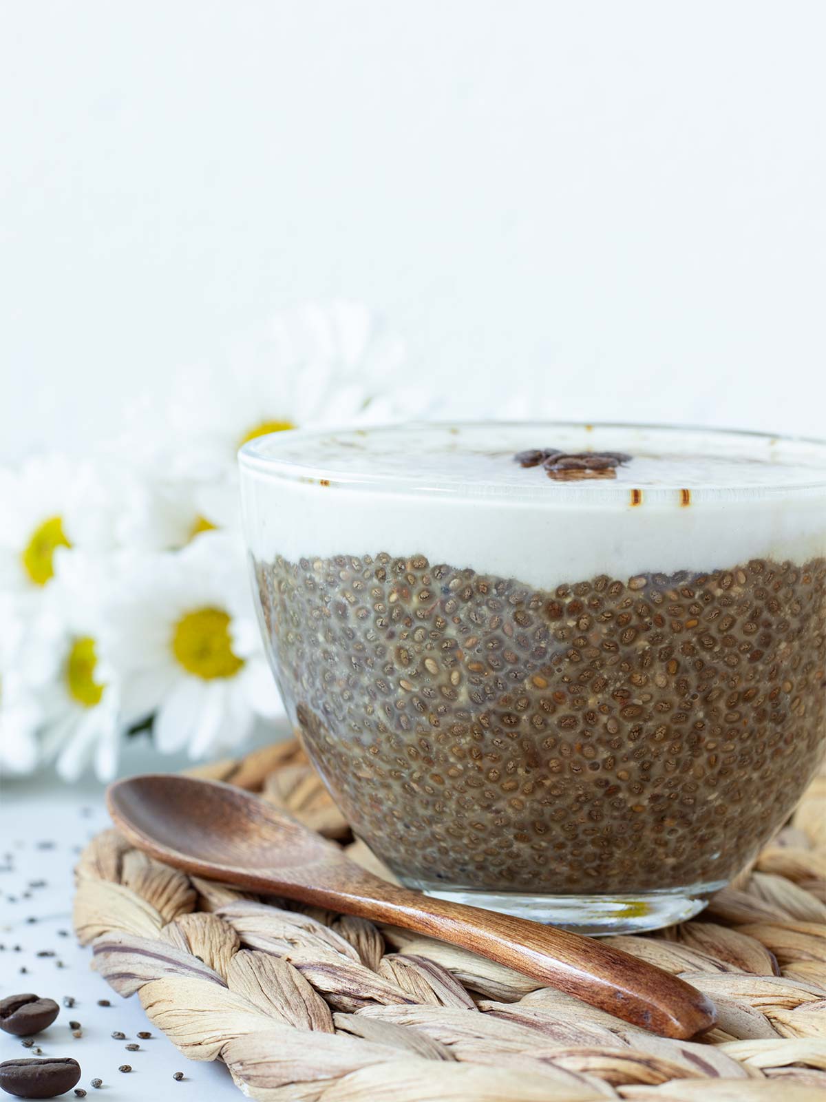 Morning cup of coffee chia pudding topped with vegan creamear.