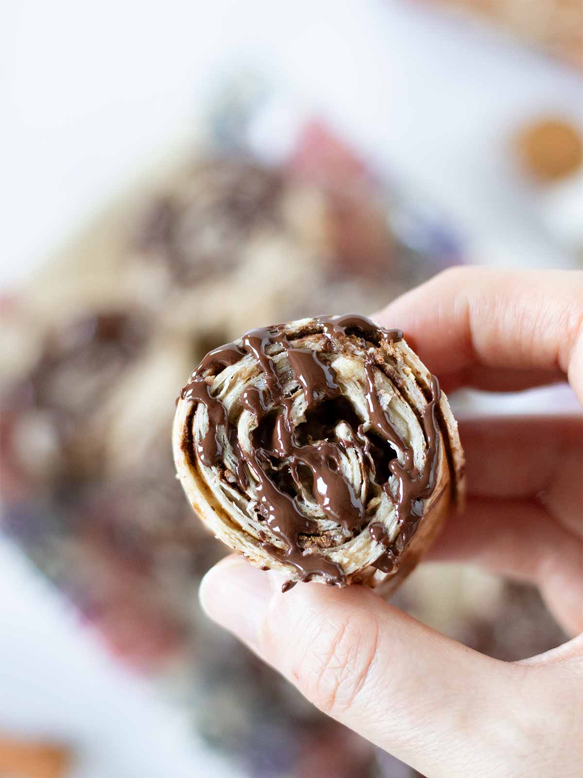 4 ingredient mini tortilla cinnamon rolls drizzled with melted dark chocolate.