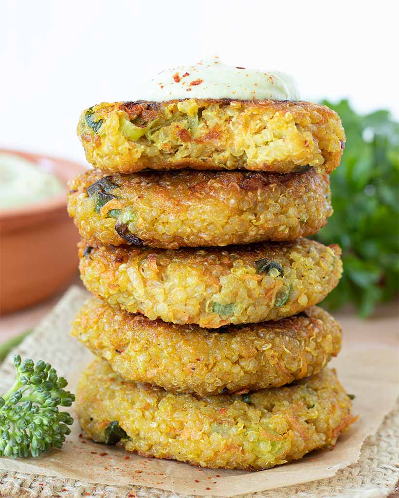 Stack of crispy vegan quinoa patties (gluten-free veggie cakes).