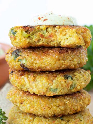 Stack of crispy vegan quinoa patties (veggie cakes).