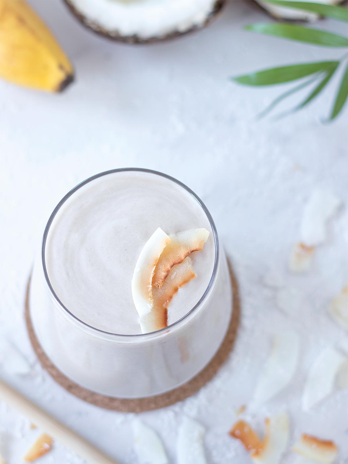 Coconut shake without ice cream topped with toasted coconut flakes.