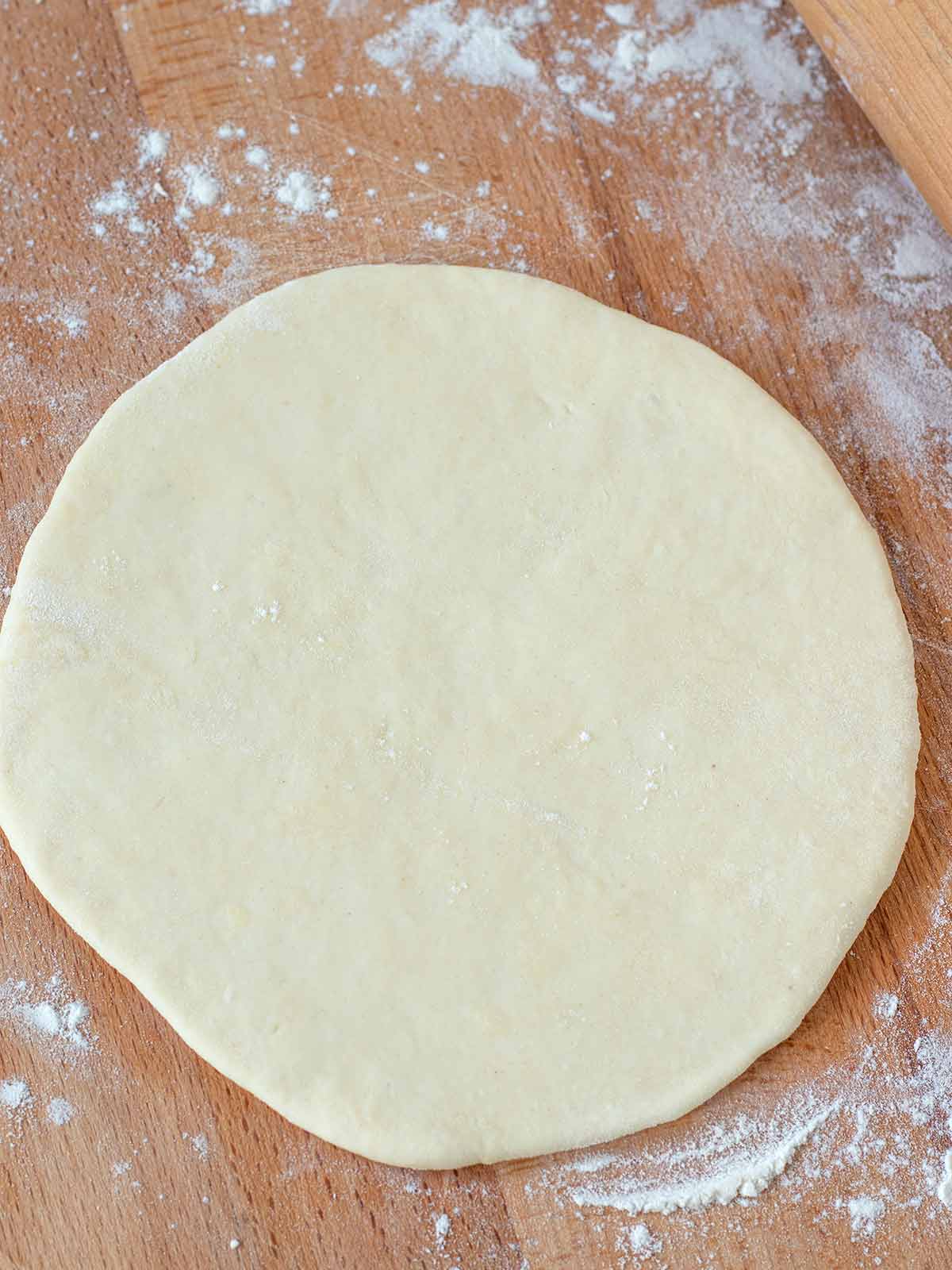 Rolled no-yeast bread on wooden table.