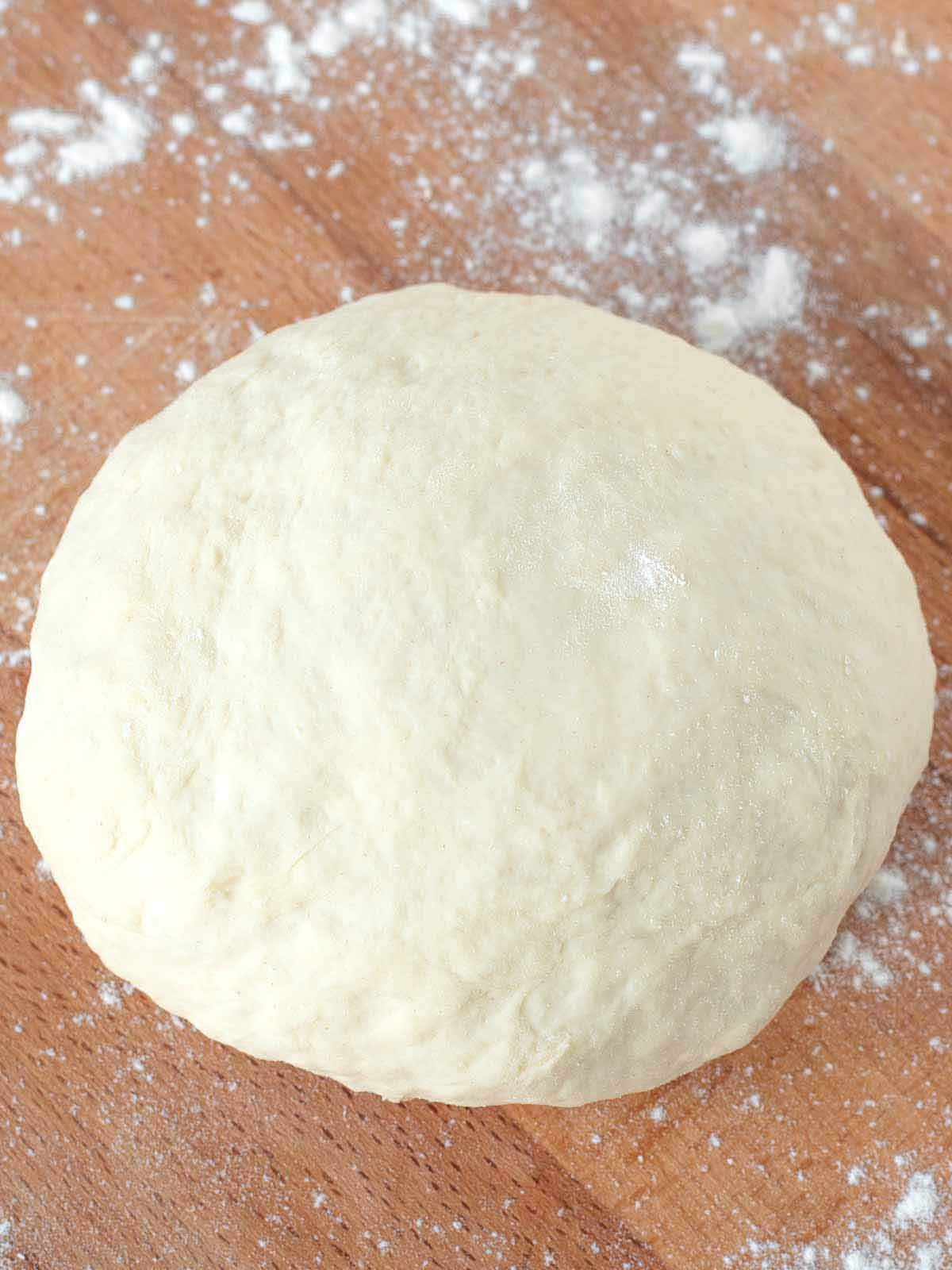 Unleavened dough on wooden surface.