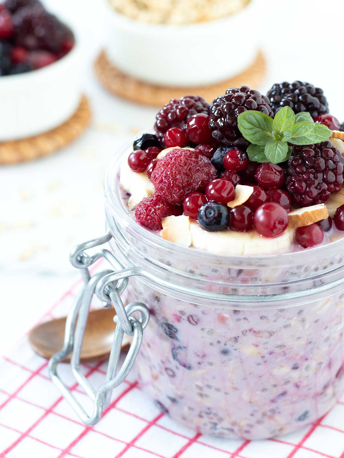 Frozen fruit overnight oats with sliced bananas and mixed berries topping.