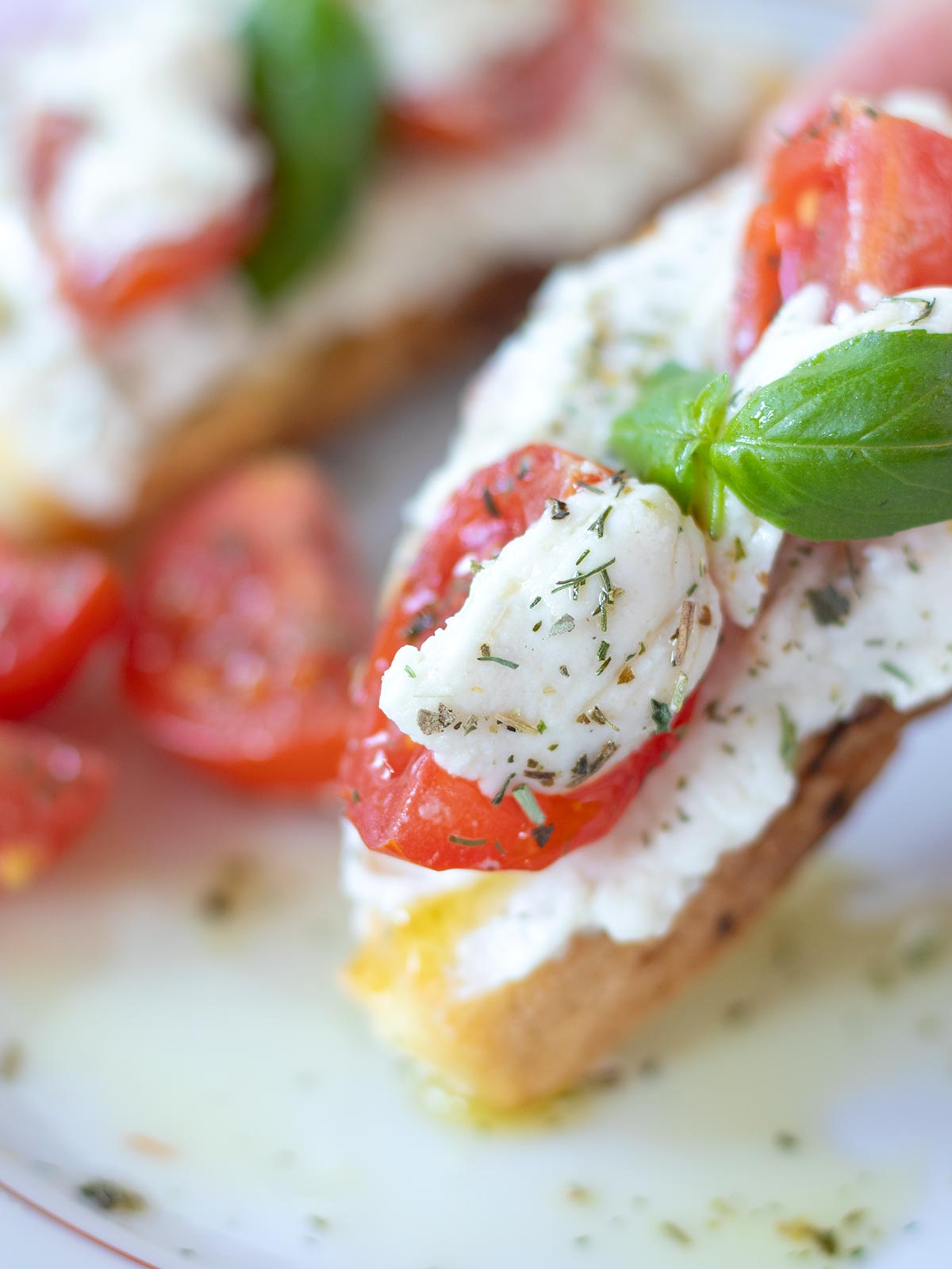 Homemade vegan substitute to burrata cheese served with crusty bread, basil, and cherry tomatoes.