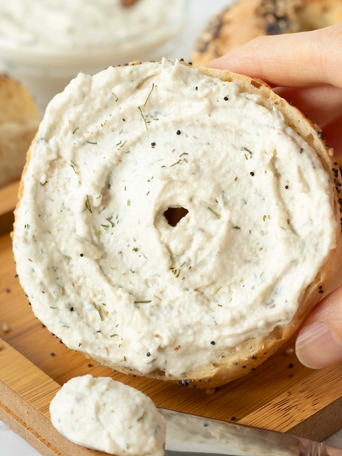 Dairy-free cream cheese with dill spread on bagel.