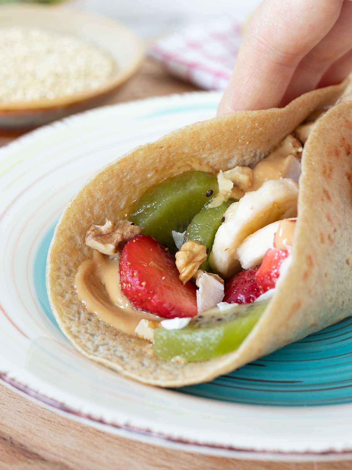Healthy quinoa crepe with sweet peanut butter and fruit filling.