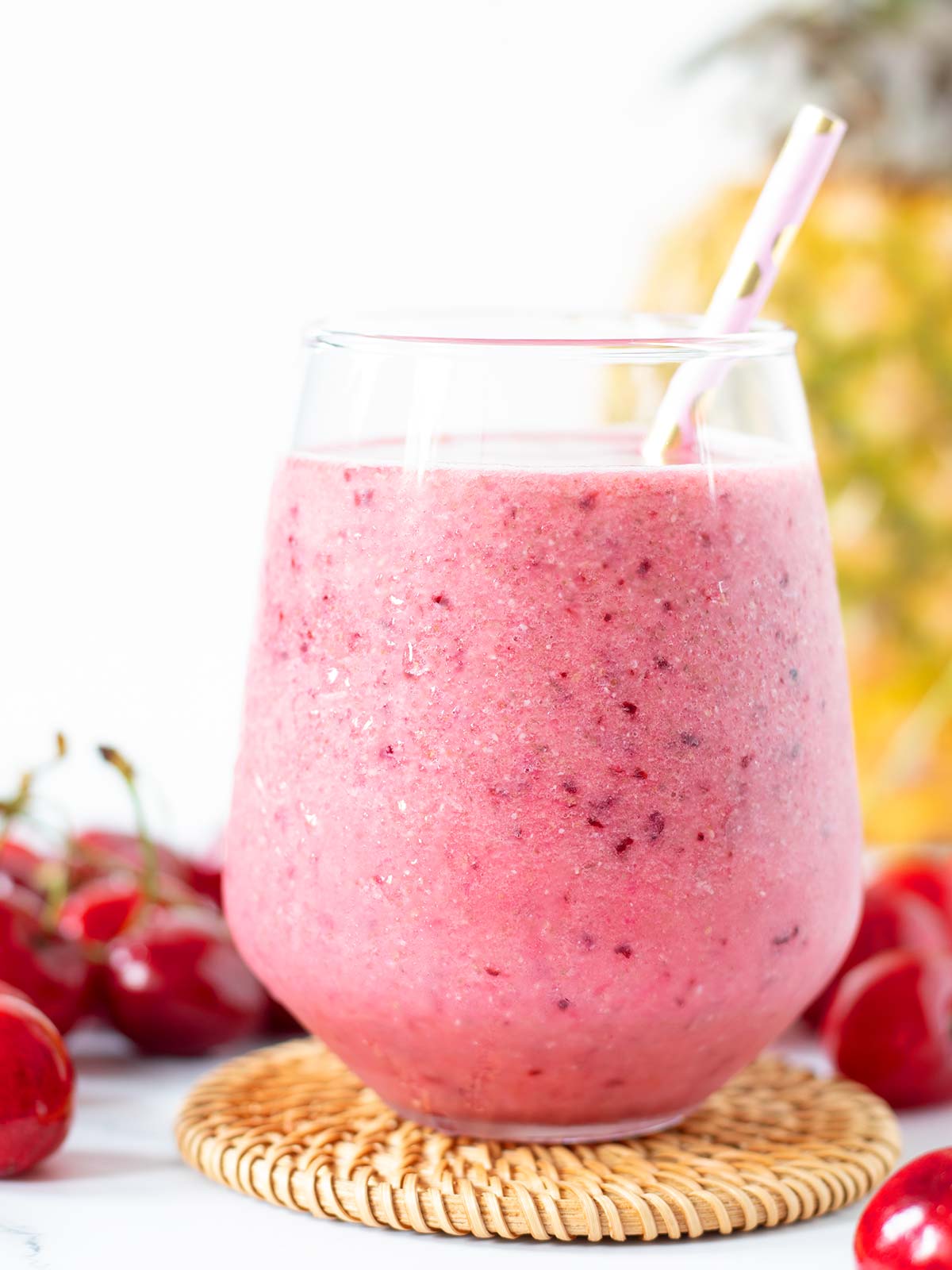 Refreshing pink cherry and pineapple summer drink.