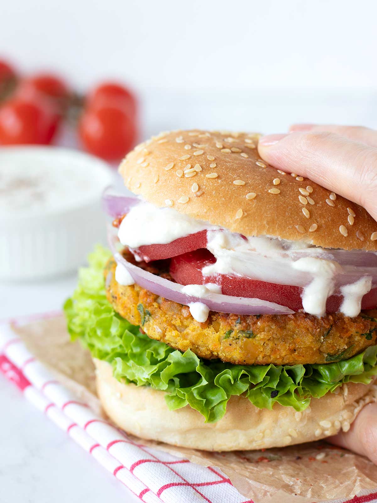 Vegan high-protein garbanzo bean fritters in sandwich burger with fresh salad.