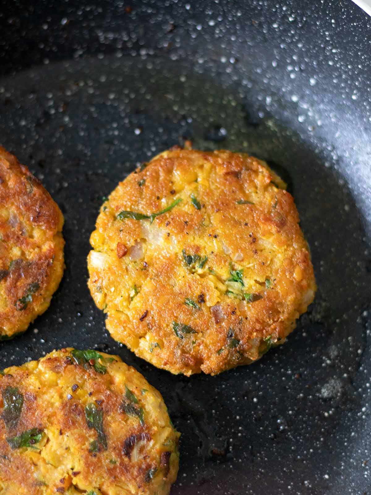 Frying protein chickpea patties.