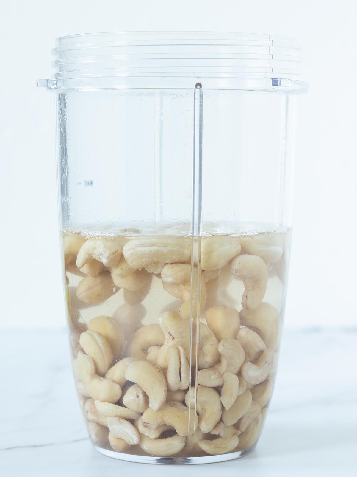 Soaking cashews in hot water for homemade vegan cheddar cheese.