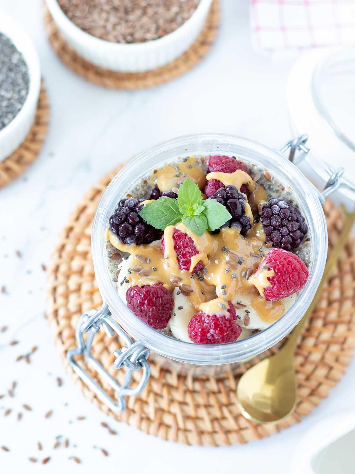 Flaxseed meal and chia pudding with healthy toppings (peanut butter and frozen fruit).