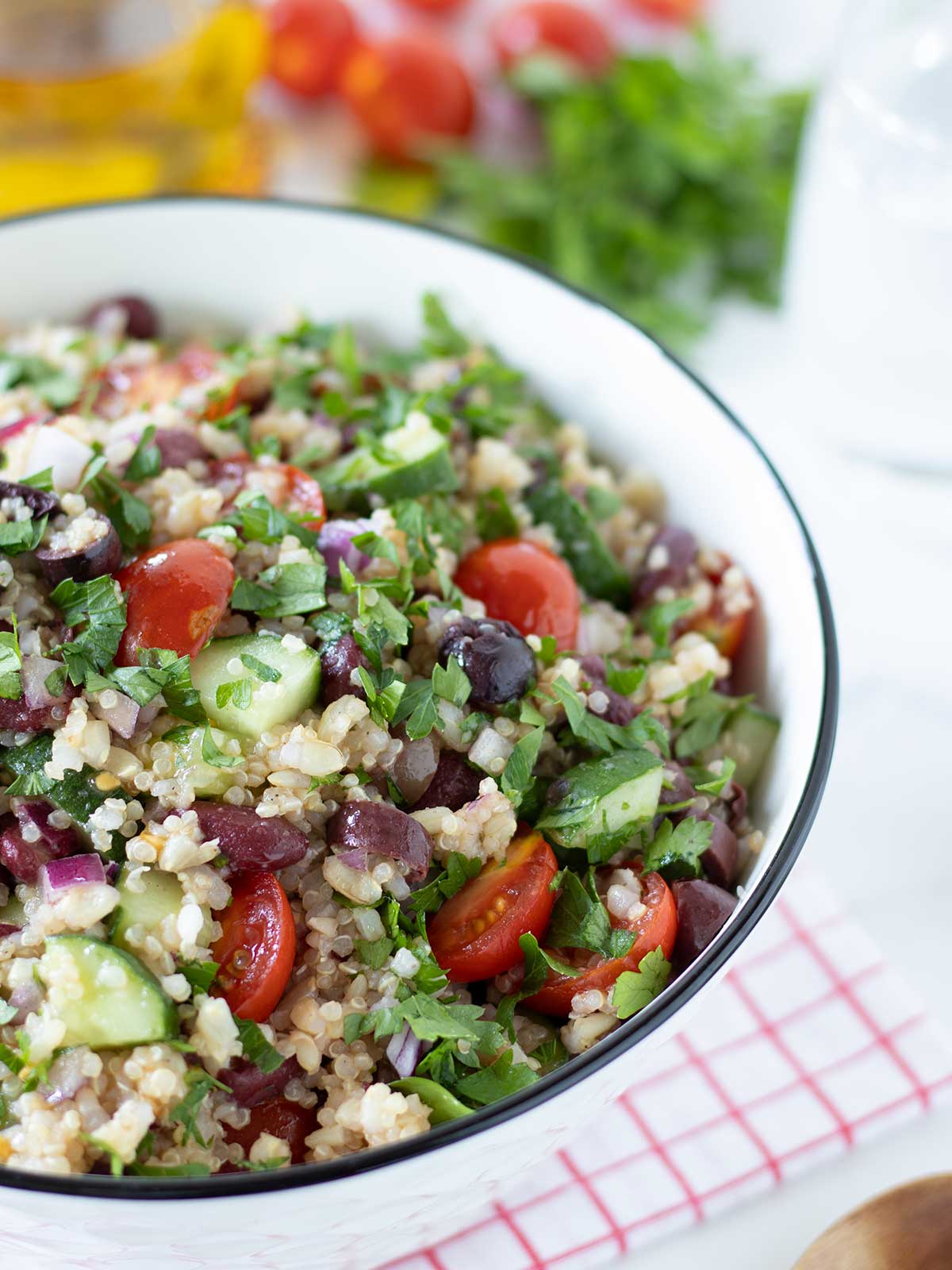 Gluten-free quinoa salad with brown rice, kidney beans, and fresh veggies.