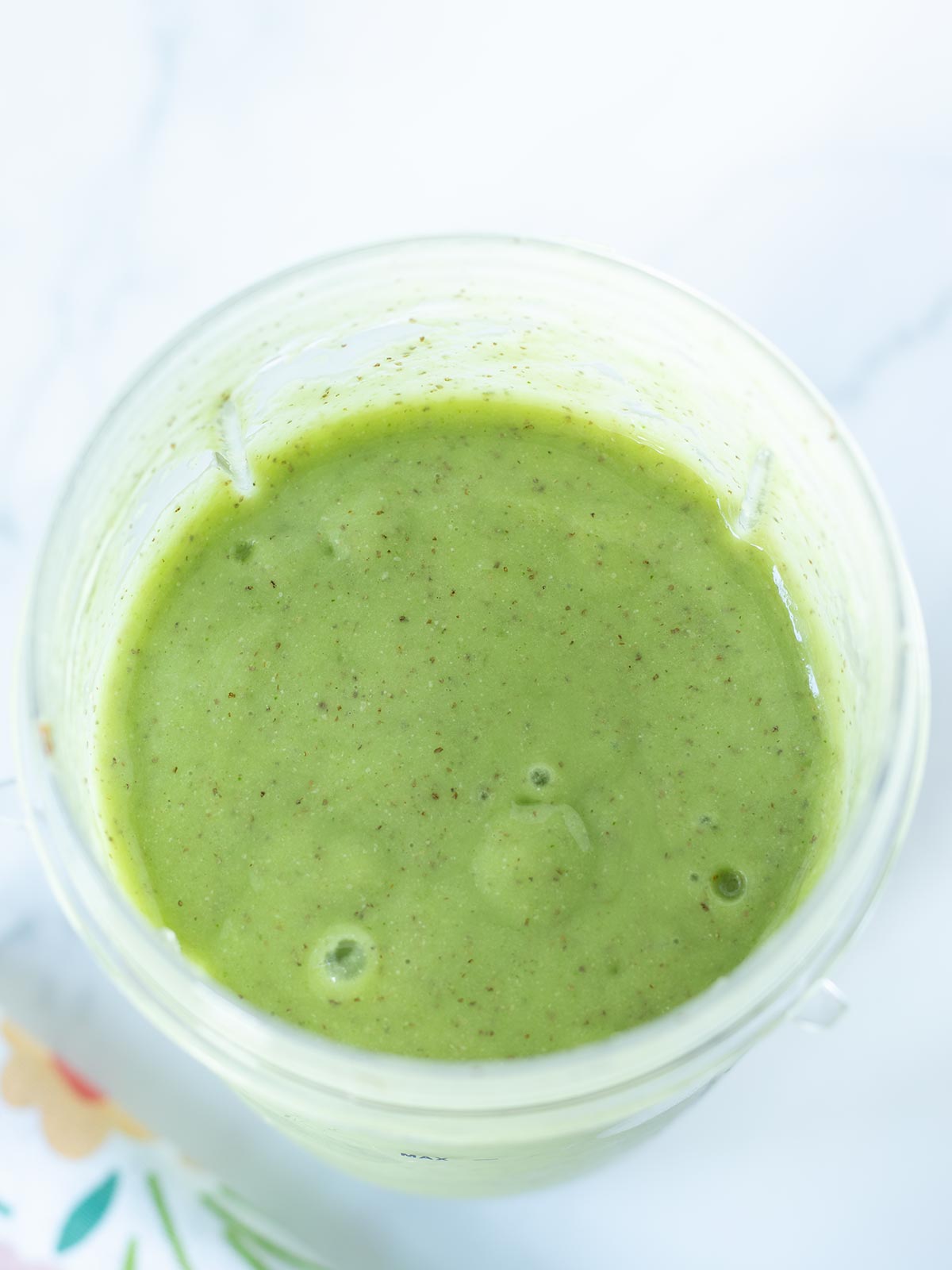 Green banana pineapple mango smoothie with spinach and chia seeds.