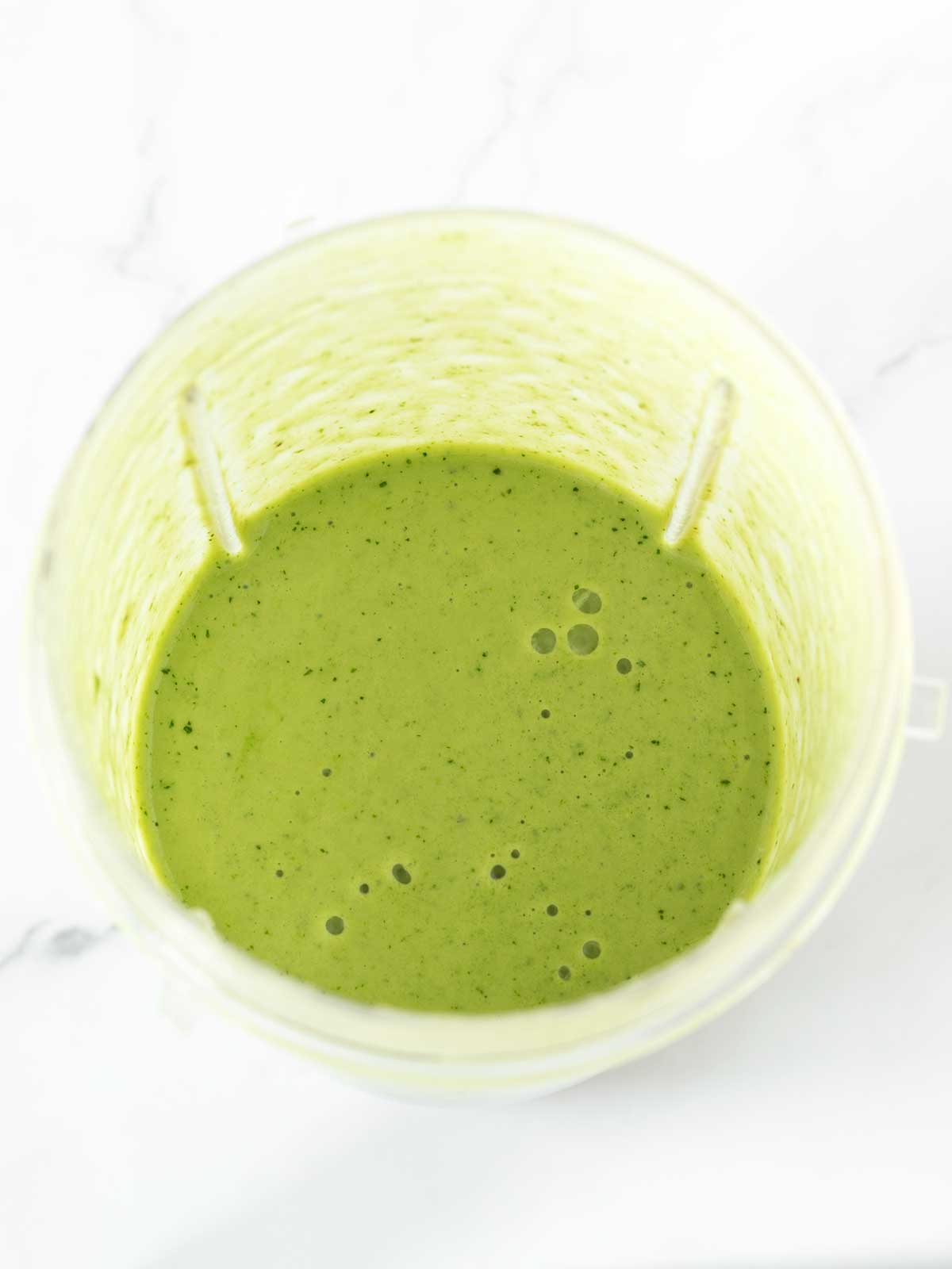 Green smoothie muffins mixture in blender.