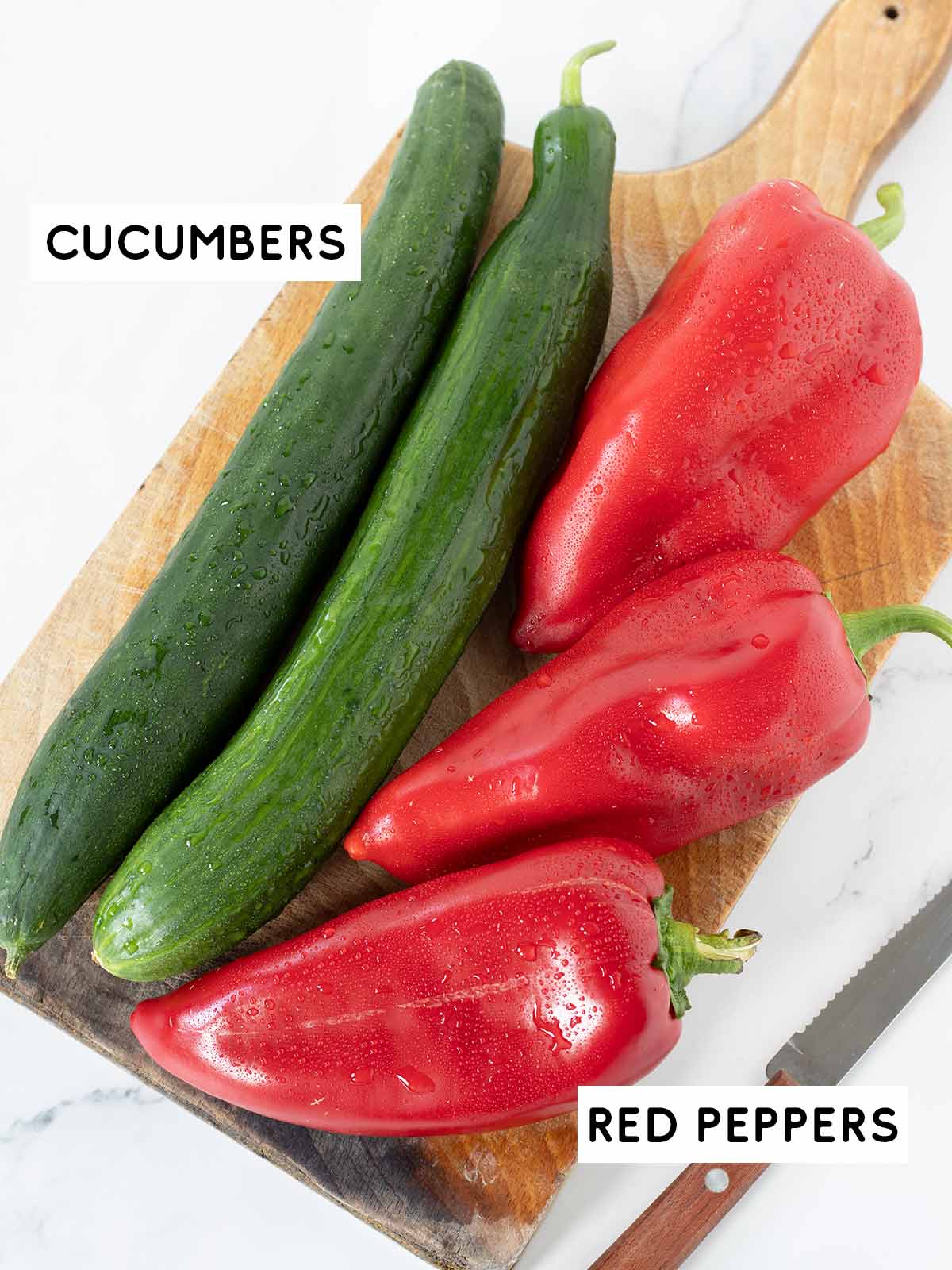 Fresh cucumbers and red peppers prepared for salad.