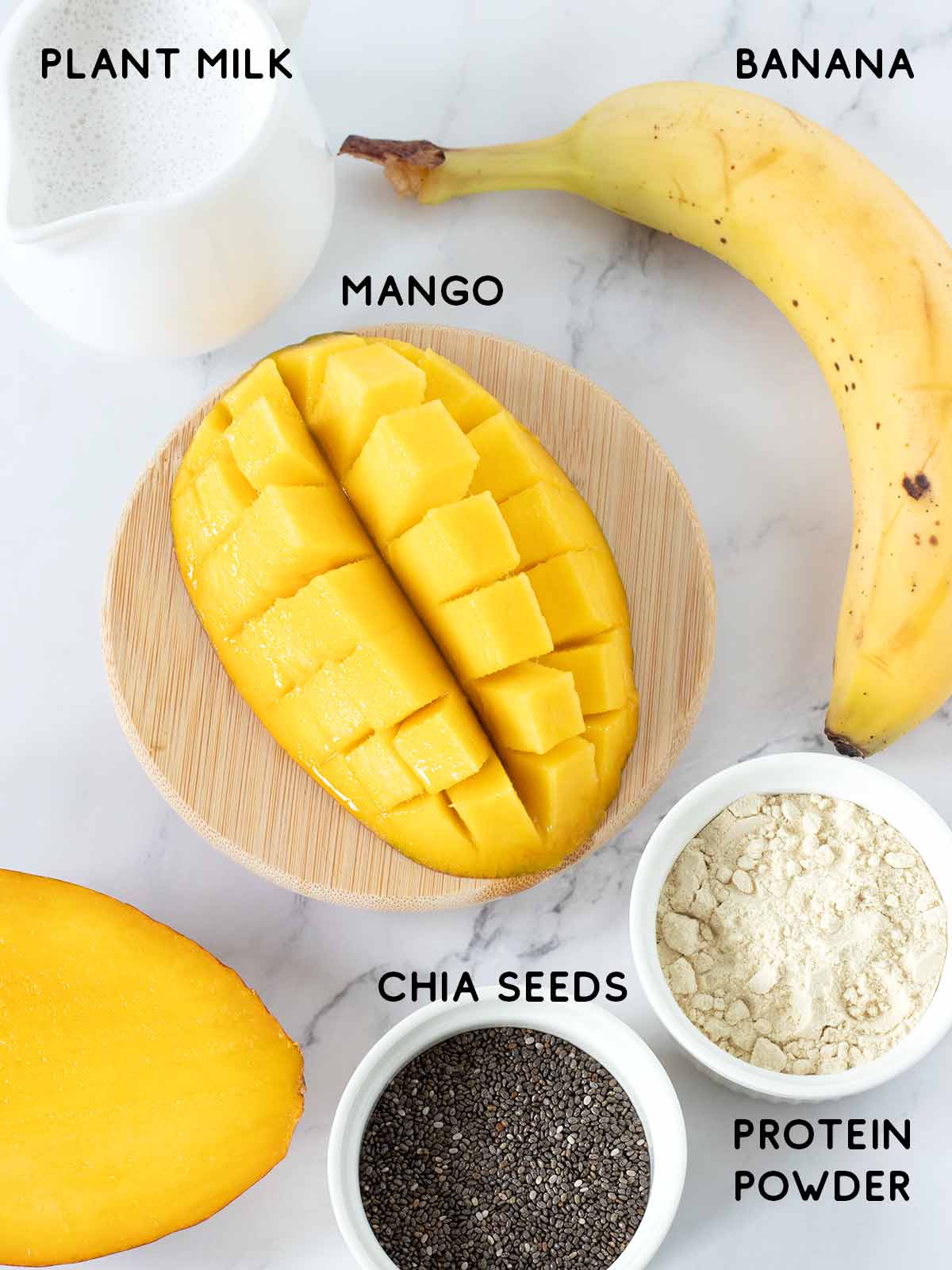 Plant-based ingredients for healthy mango banana vanilla protein powder smoothie recipe.