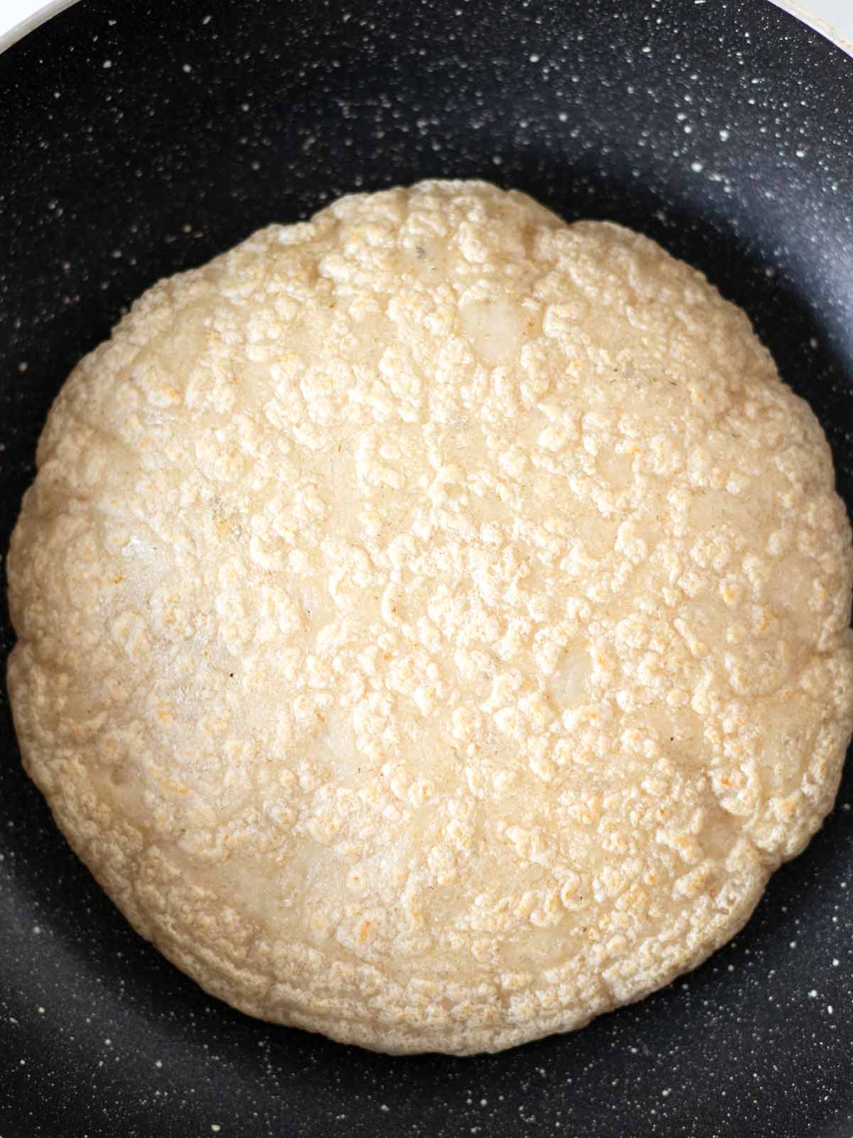 Cooked unleavened soft oat tortilla.