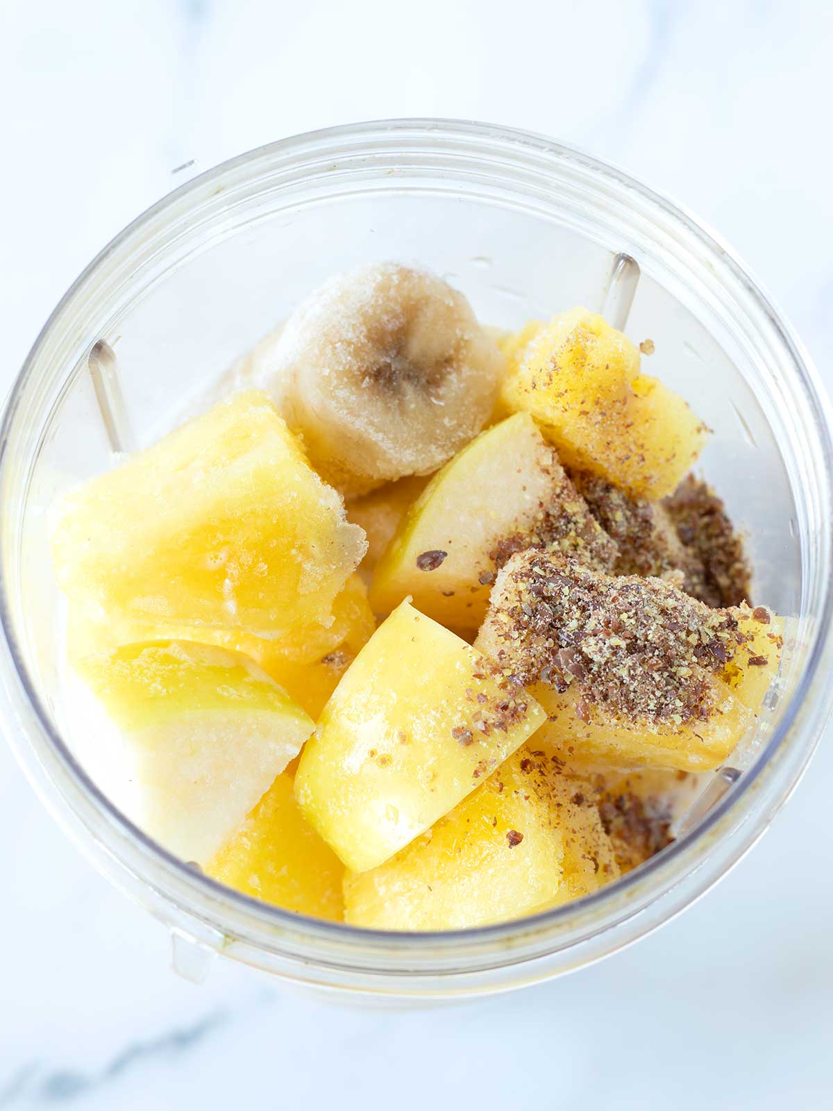 Apple and pineapple smoothie ingredients.