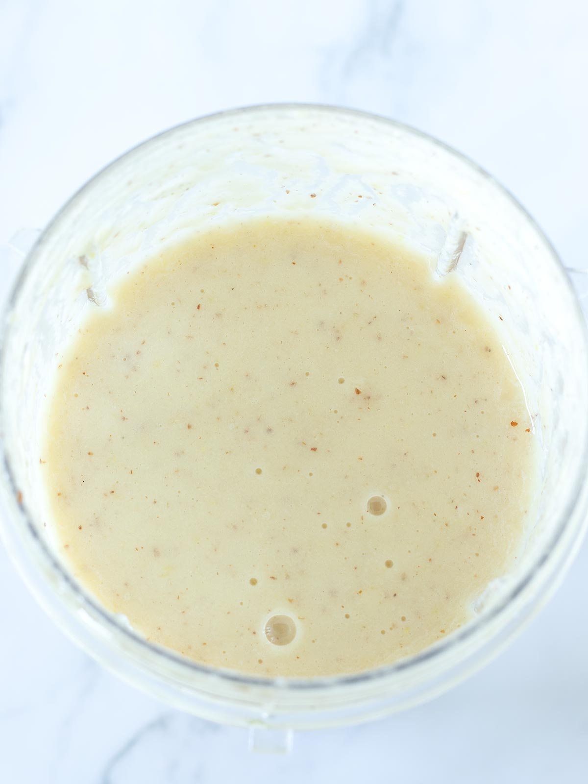 Blended apple banana pineapple smoothie.