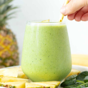 Green spinach pineapple banana smoothie with almond milk.