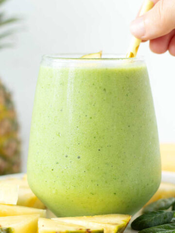 Green spinach pineapple banana smoothie with almond milk.