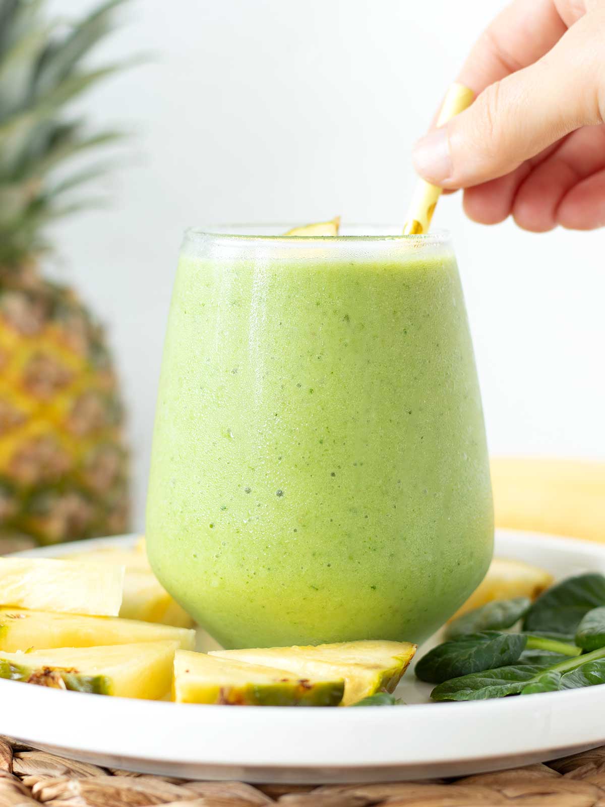 Green spinach pineapple banana smoothie with almond milk.