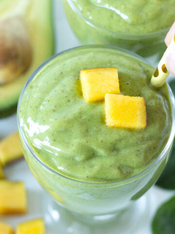 Green mango avocado smoothie with banana and spinach.