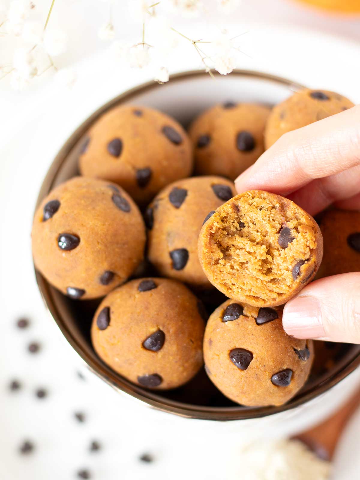 Healthy pumpkin energy bites with vanilla protein powder, peanut butter, oat flour and chocolate chips.